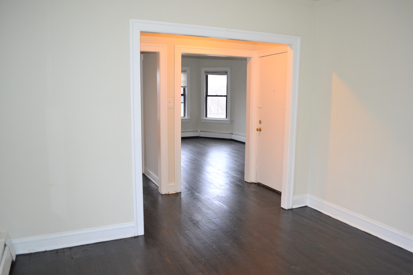 2948 West Nelson Street, Unit 3 Chicago, IL 60618 - Photo 4 of 14 an empty room with wooden floor and a window
