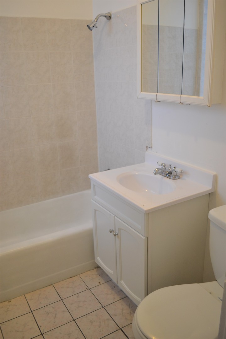 2948 West Nelson Street, Unit 3 Chicago, IL 60618 - Photo 7 of 14 a bathroom with a sink a toilet and bathtub