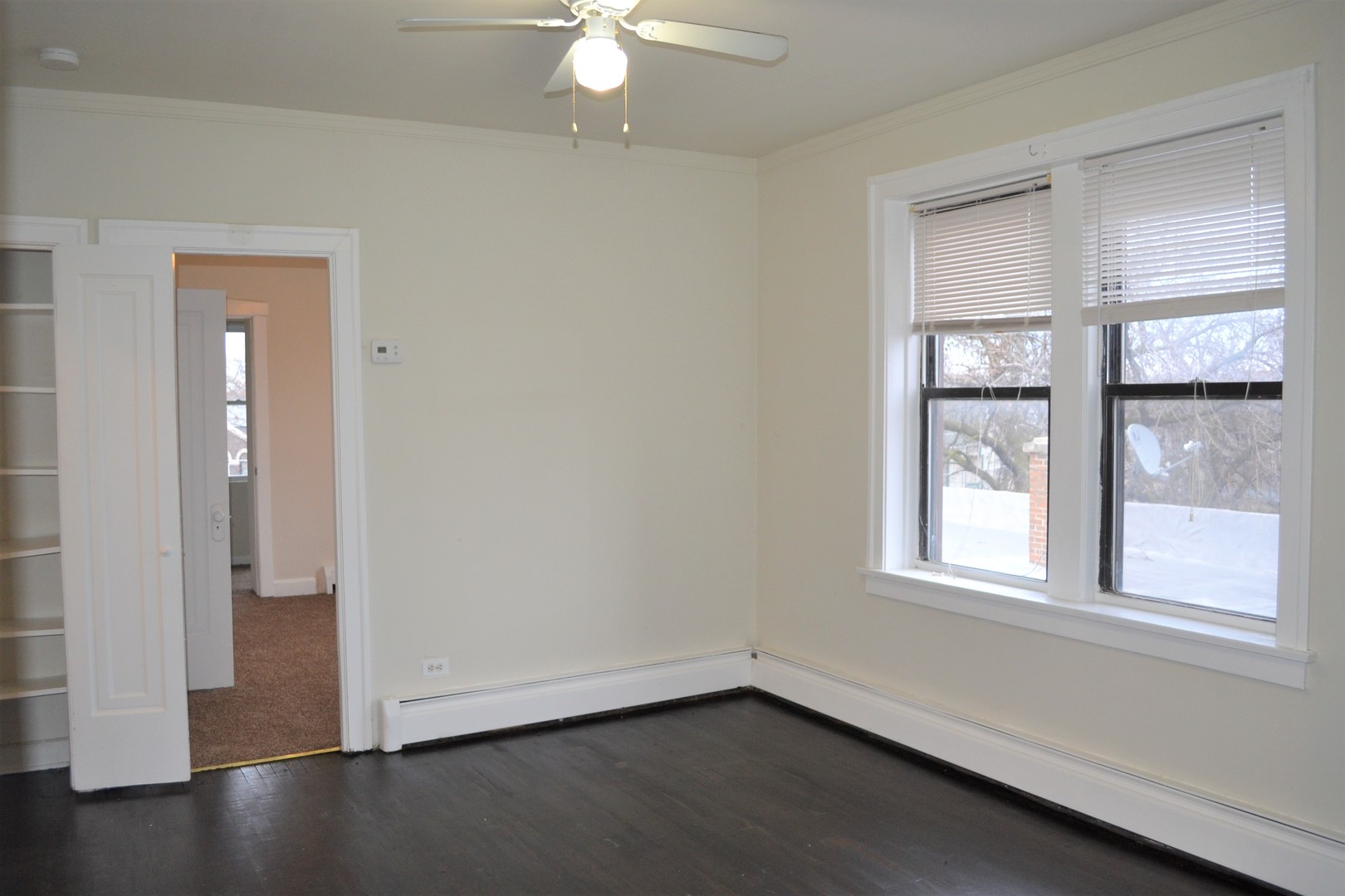 2948 West Nelson Street, Unit 3 Chicago, IL 60618 - Photo 10 of 14 an empty room with wooden floor closet and windows