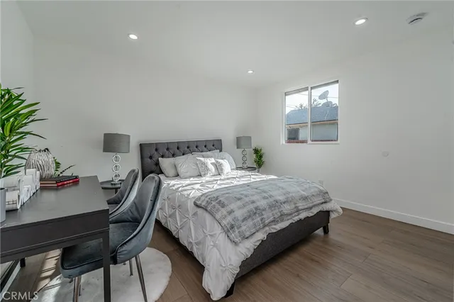 a bedroom with a bed and a potted plant