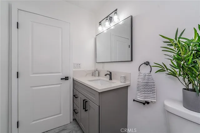 a bathroom with a sink a mirror and vanity
