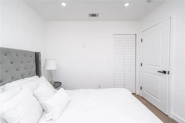 a bedroom with a bed and a cabinet