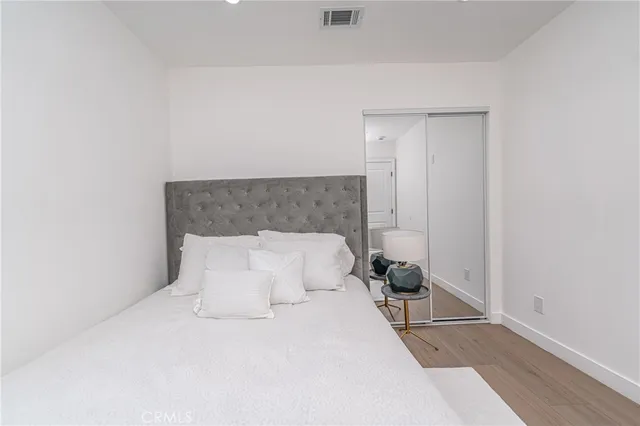 a bedroom with a bed and a potted plant