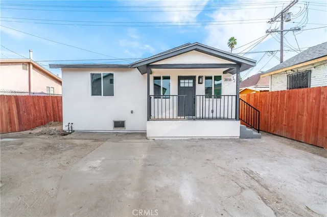 a view of a house with wooden fence