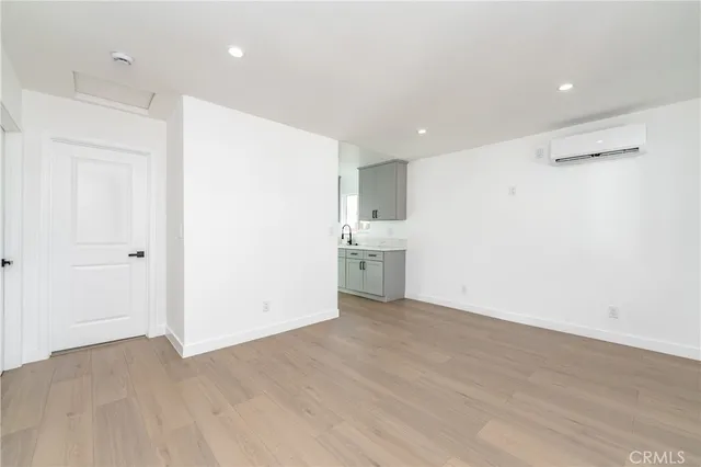 a view of a kitchen with a sink and a refrigerator