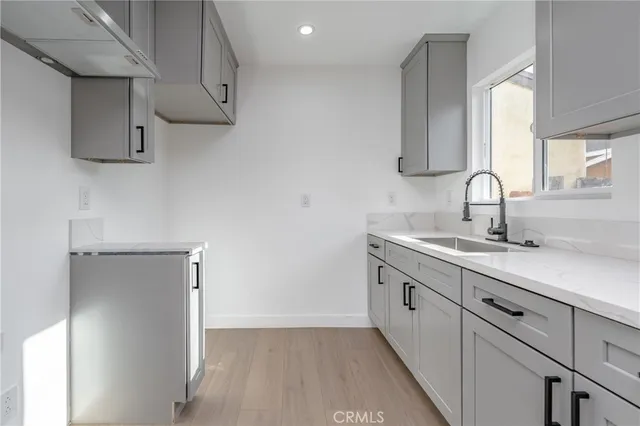 a kitchen with stainless steel appliances a sink stove and cabinets