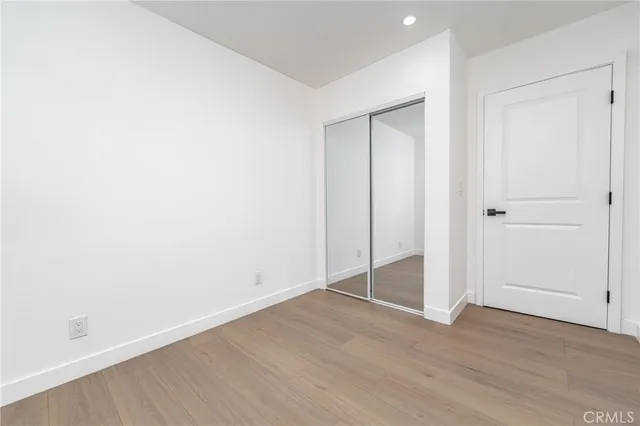 an empty room with wooden floor