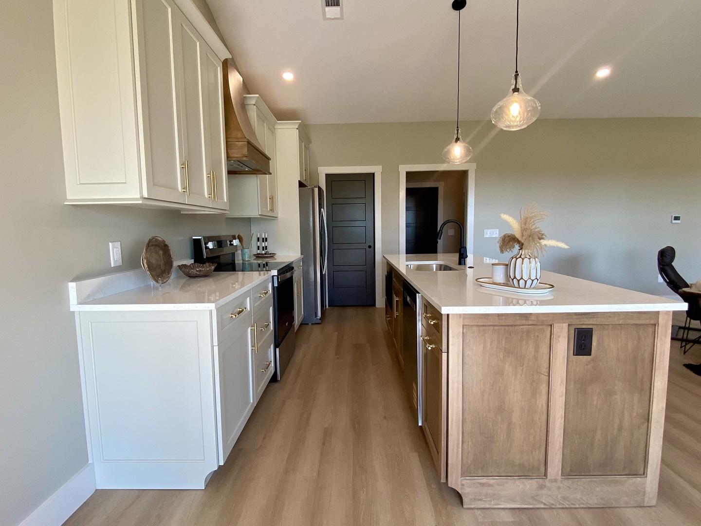 1619 Peppermill Lane Champaign, IL 61822 - Photo 13 of 31 a kitchen that has a sink a microwave oven a stove and white cabinets with wooden floor