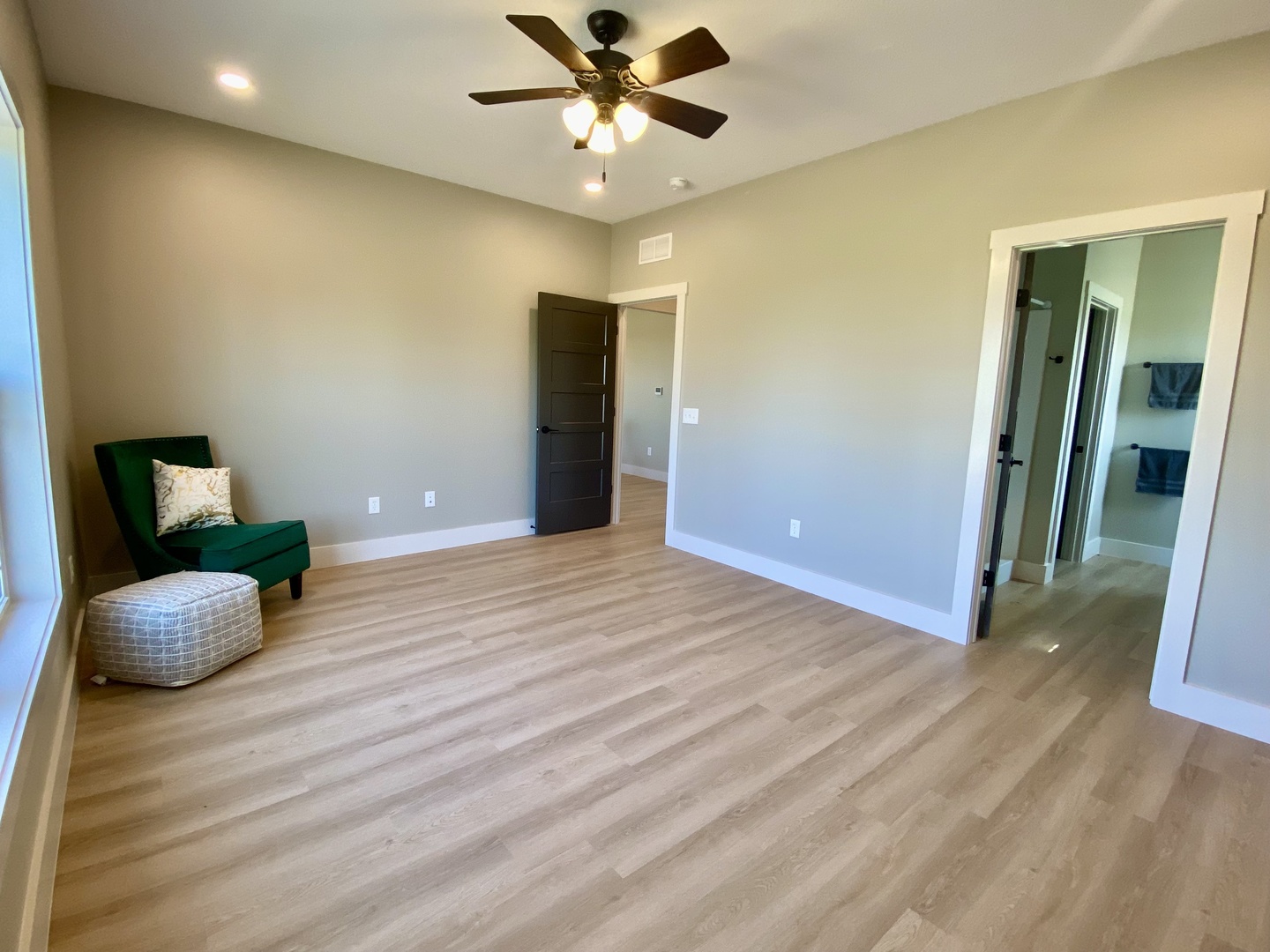 1619 Peppermill Lane Champaign, IL 61822 - Photo 23 of 31 a view of an empty room with wooden floor and a ceiling fan