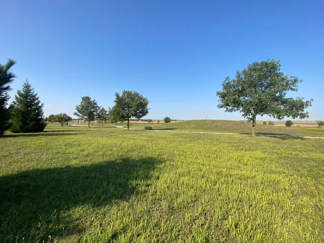 a view of a house with a patio and a yard