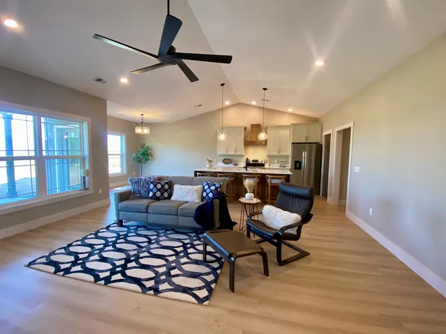 a living room with furniture and kitchen view