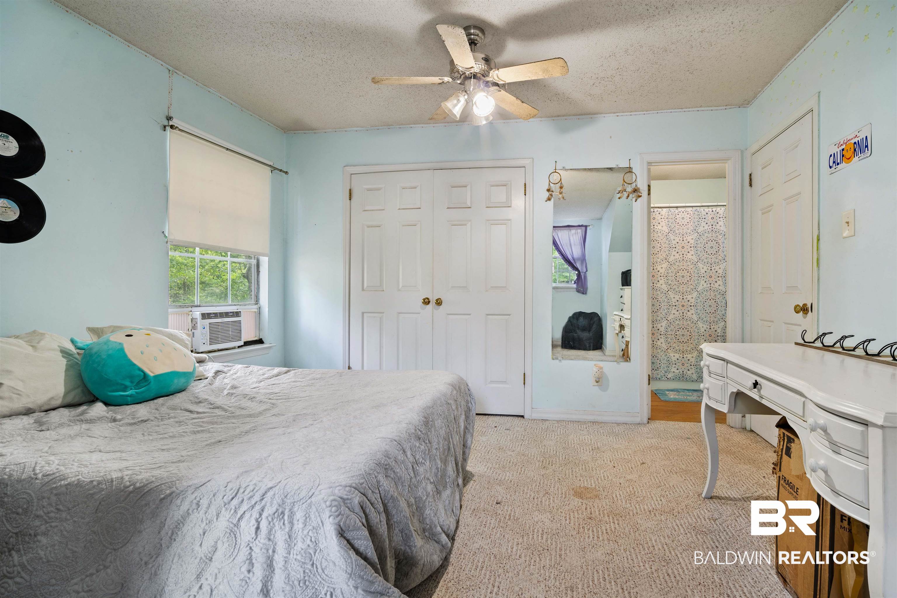 2823 Woodland Road Mobile, AL 36693 - Photo 17 of 29 Bedroom with a ceiling fan, light carpet, a closet, cooling unit, and a textured ceiling