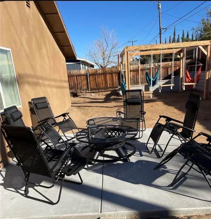 a view of a patio with table and chairs with wooden floor