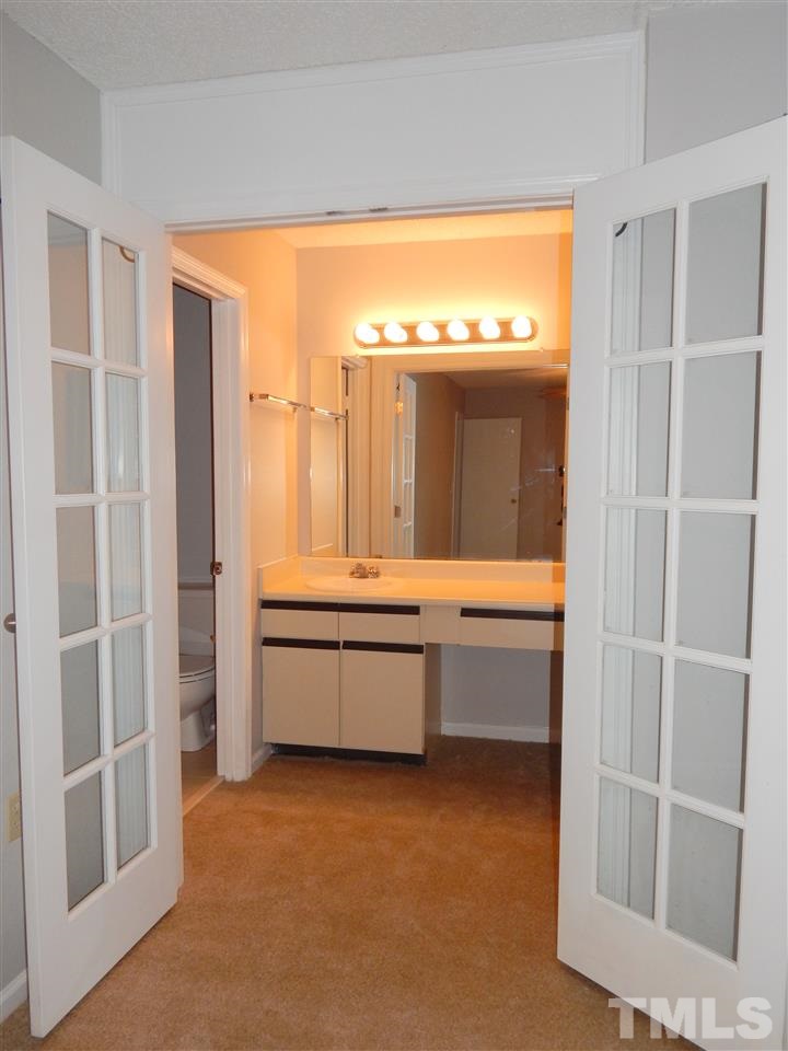 7707 Falcon Rest Circle, Unit 7707 Raleigh, NC 27615 - Photo 11 of 19 a bathroom with a tub sink and mirror