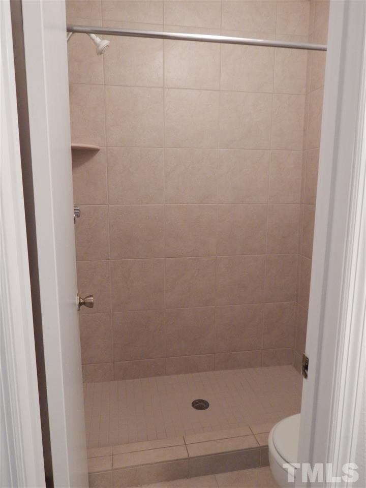 7707 Falcon Rest Circle, Unit 7707 Raleigh, NC 27615 - Photo 12 of 19 a bathroom with a shower and a toilet