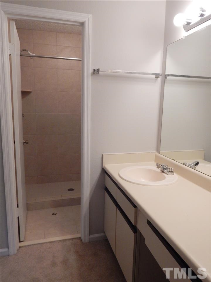 7707 Falcon Rest Circle, Unit 7707 Raleigh, NC 27615 - Photo 13 of 19 a bathroom with a sink and a mirror