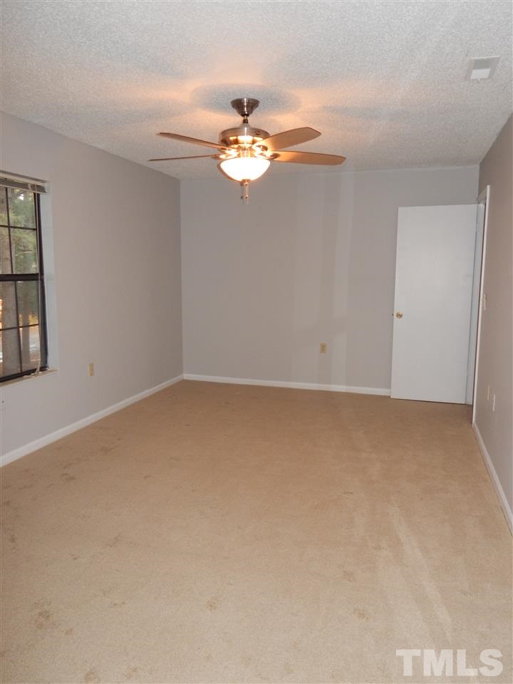 7707 Falcon Rest Circle, Unit 7707 Raleigh, NC 27615 - Photo 14 of 19 a view of wooden floor and chandelier fan in a room