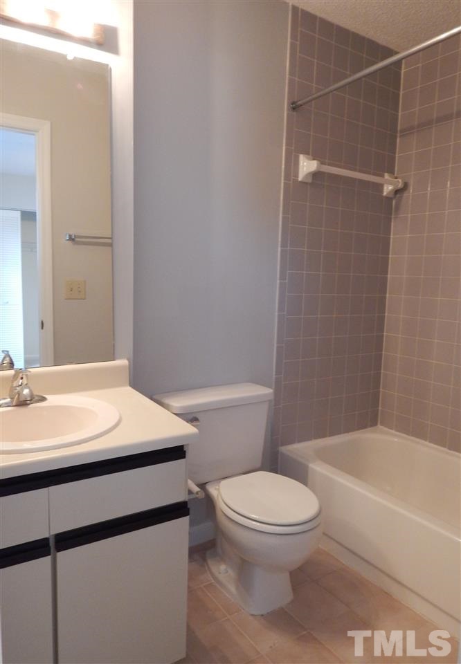 7707 Falcon Rest Circle, Unit 7707 Raleigh, NC 27615 - Photo 17 of 19 a bathroom with a toilet a sink and a bathtub