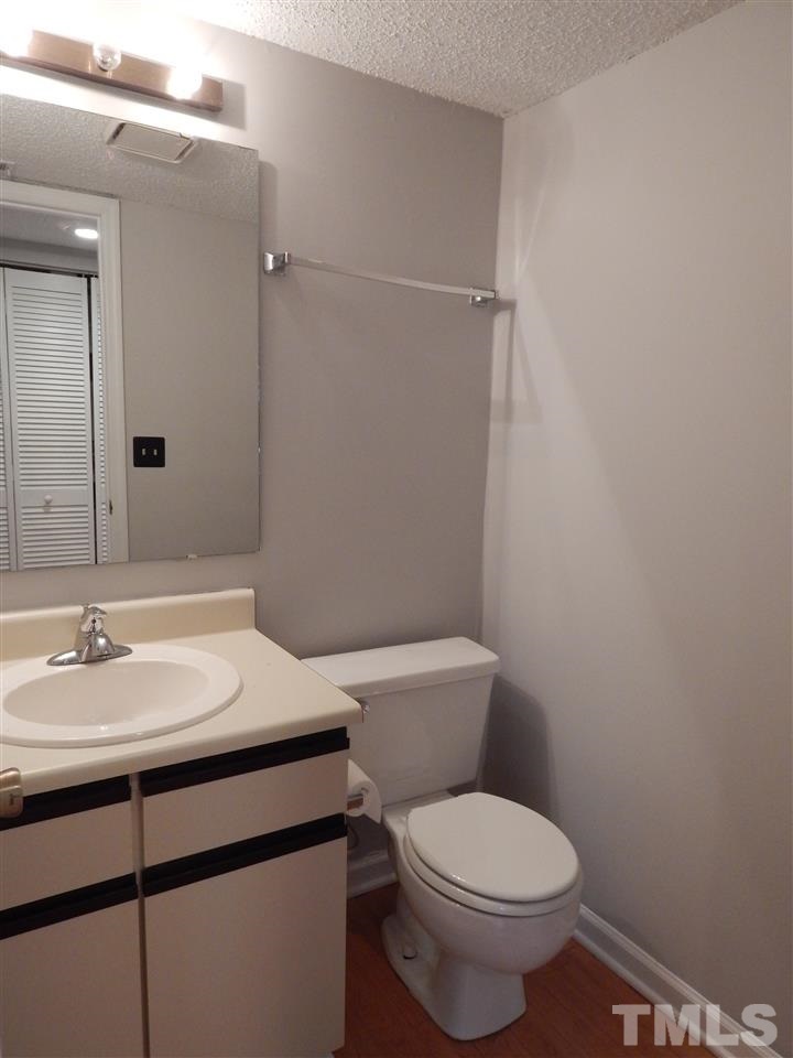 7707 Falcon Rest Circle, Unit 7707 Raleigh, NC 27615 - Photo 8 of 19 a bathroom with a sink toilet and vanity