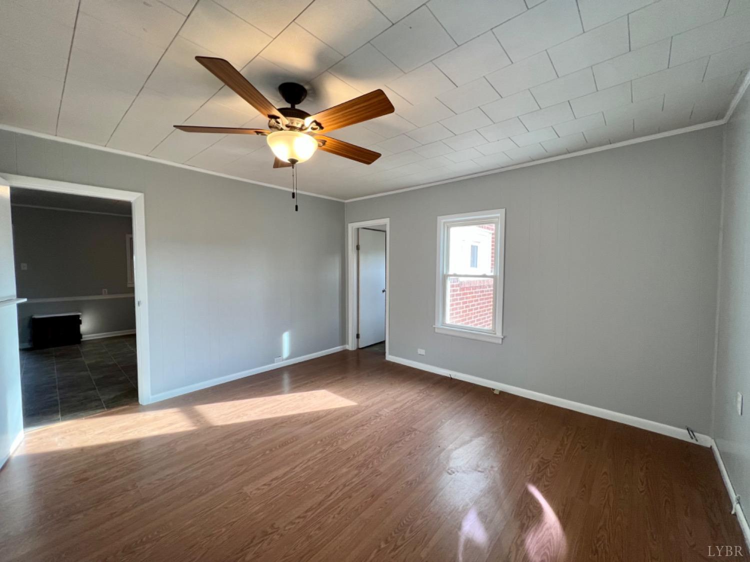 295 Little Cub Road Appomattox, VA 24522 - Photo 18 of 89 an empty room with wooden floor fan and windows