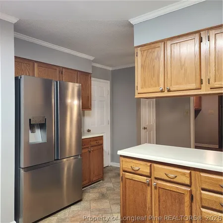 a kitchen with granite countertop cabinets and window