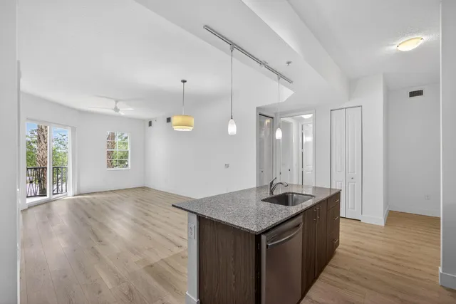 a view of a room with wooden floor and window