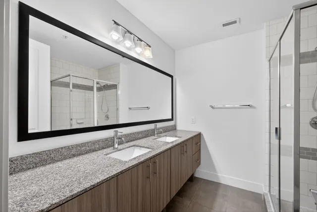 a bathroom with a glass shower door