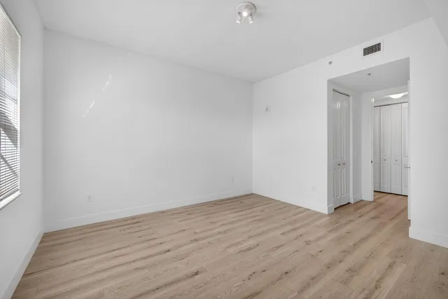 a bathroom with a granite countertop sink mirror vanity and toilet