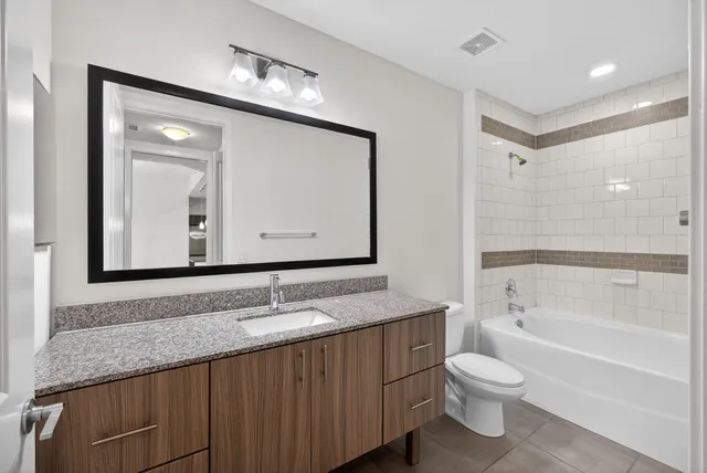 a view of a room that has a large window and wooden floor