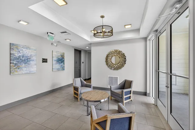 a view of a room with a table and chairs