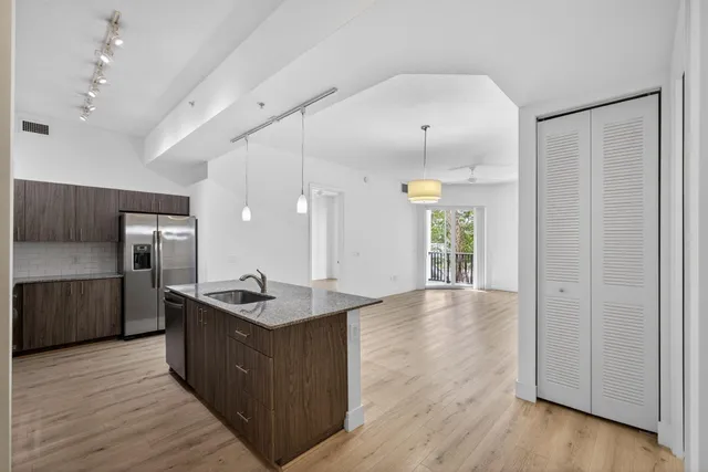 a kitchen with stainless steel appliances granite countertop a stove and a refrigerator