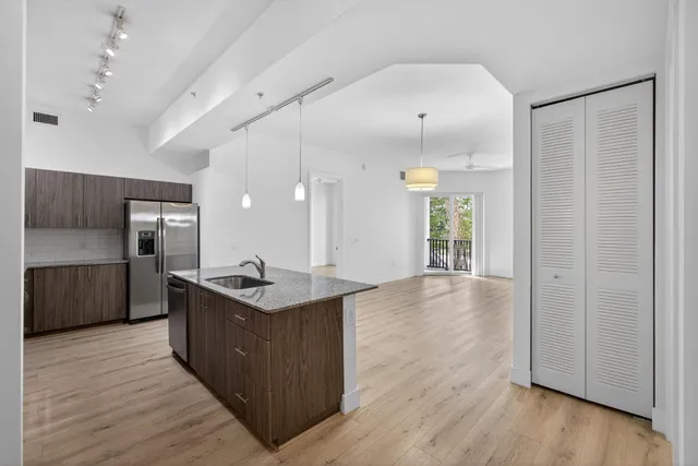a kitchen with granite countertop a sink stove and cabinets