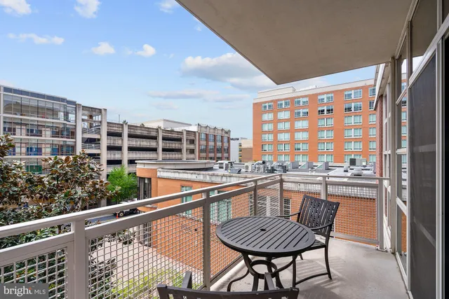 a bathroom with a granite countertop sink a toilet and a mirror