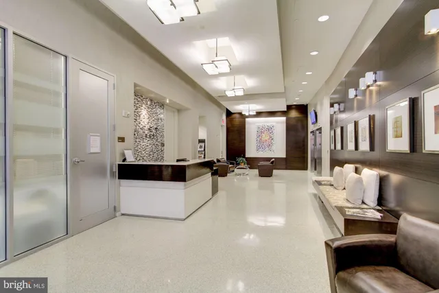 a living room with stainless steel appliances kitchen island granite countertop furniture and a view of living room