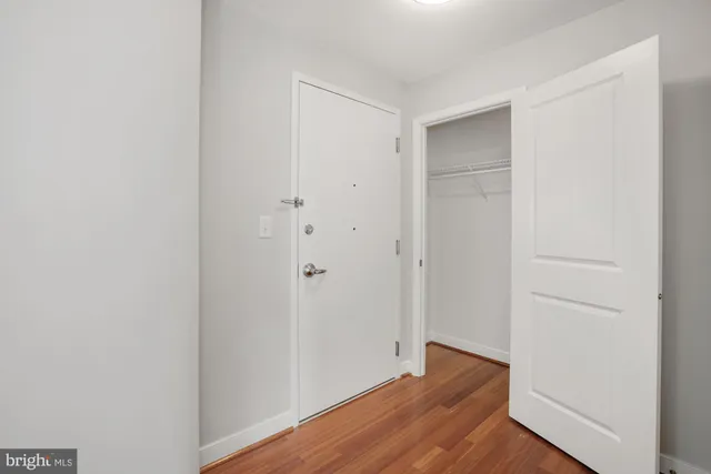 a view of an empty room with wooden floor