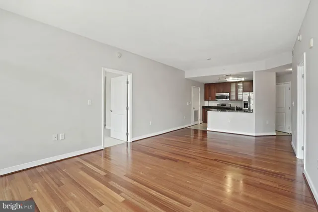 a view of a kitchen with wooden floor and a kitchen