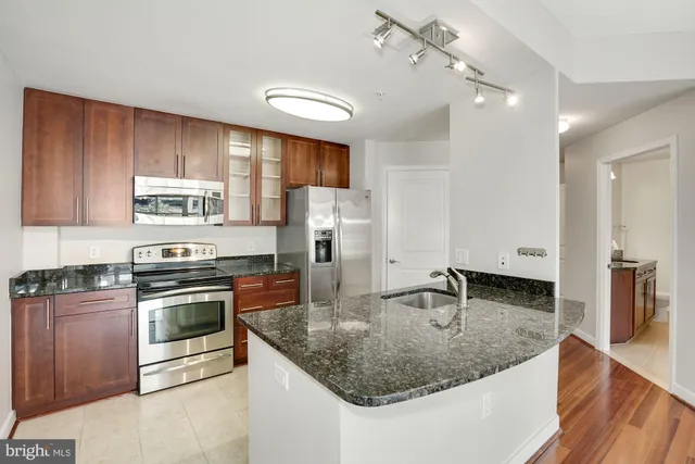 a view of a kitchen with wooden floor and a sink