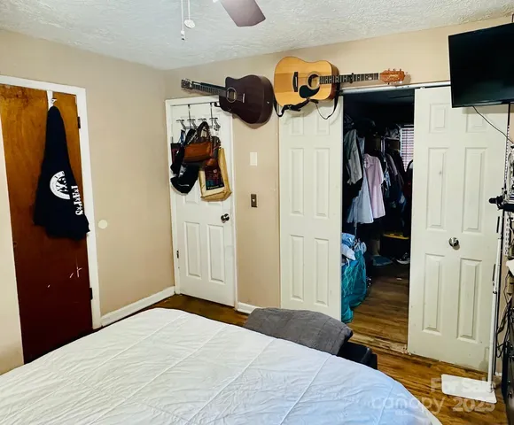 a bedroom with a walk in closet and closet