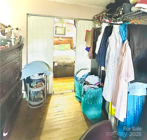 a floor to ceiling window and painting on the wall