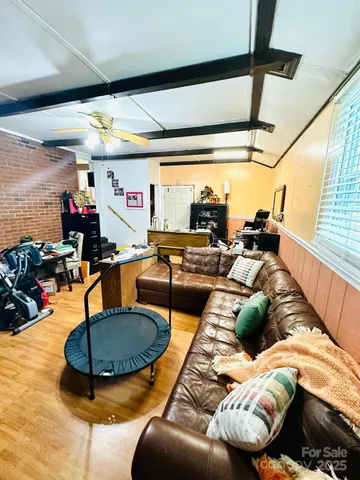 a living room with furniture and a floor to ceiling window