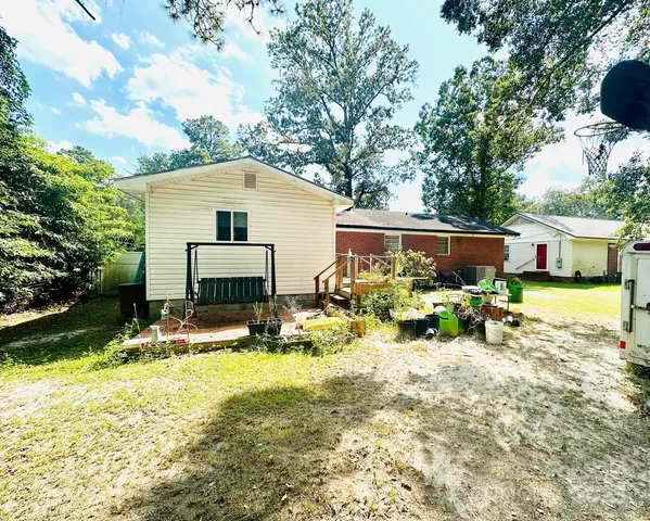 a view of a house with backyard porch and sitting area