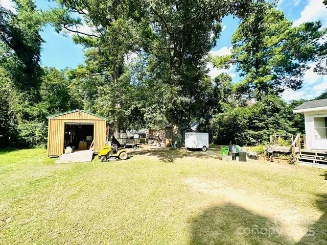 a view of a swimming pool with a yard and sitting area
