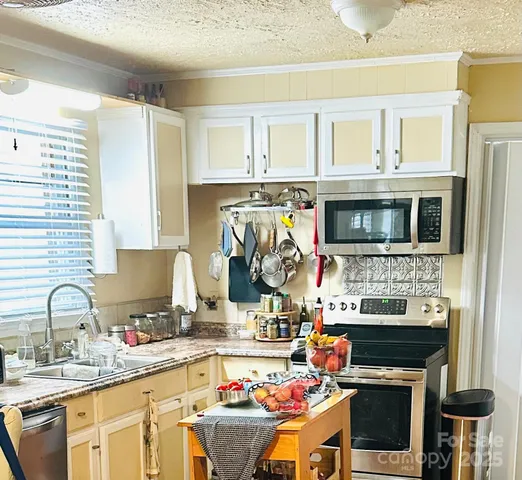 a kitchen with stainless steel appliances granite countertop a stove and a sink