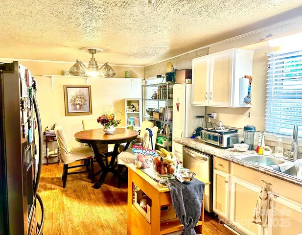 a view of a dining room with furniture and a kitchen