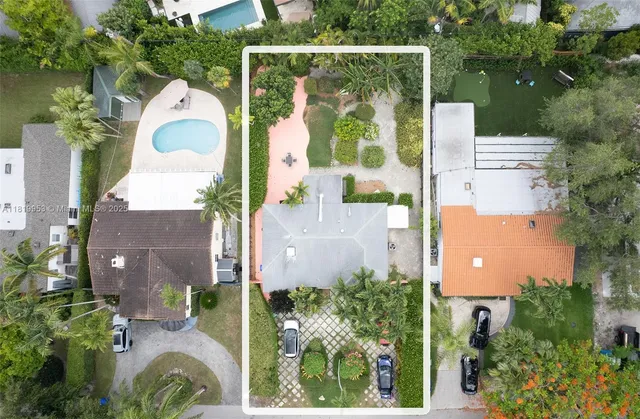 an aerial view of a house with pool and garden