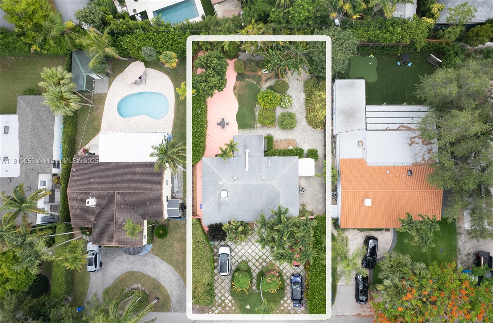 an aerial view of a house with pool and garden