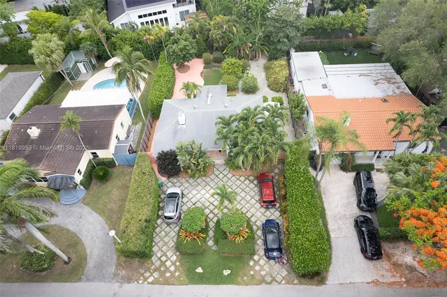 an aerial view of a house with a yard and garden