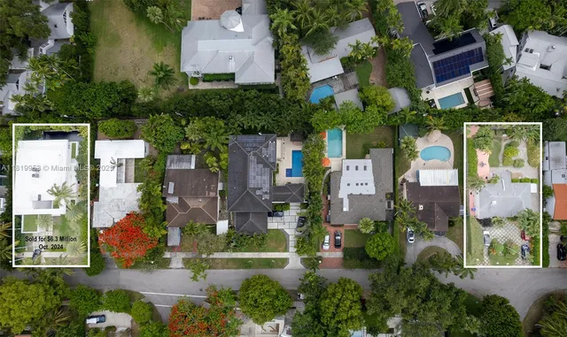 an aerial view of multiple houses with yard