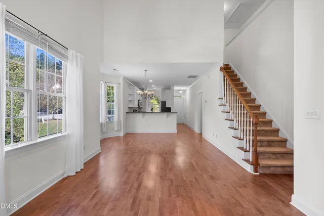 a view of entryway and hall with wooden floor