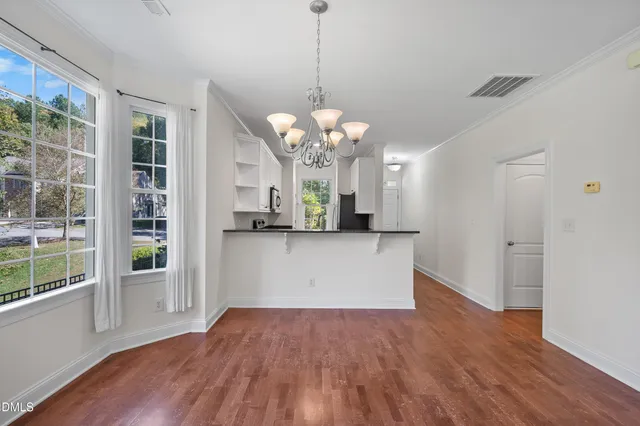 a view of a house with wooden floor and a large window